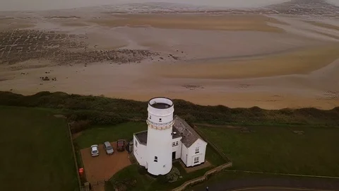 Hunstanton cliffs and lighthouse aerial Stock Footage 121108615