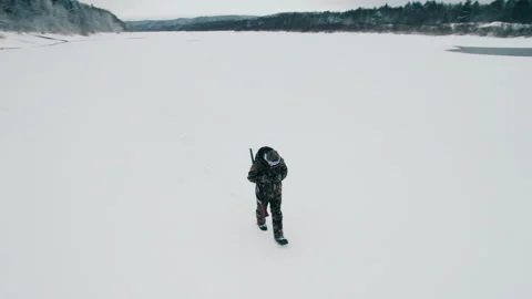 The hunter aims at the prey with a gun, preparing to shoot. Aerial photography. Stock Footage 295369106