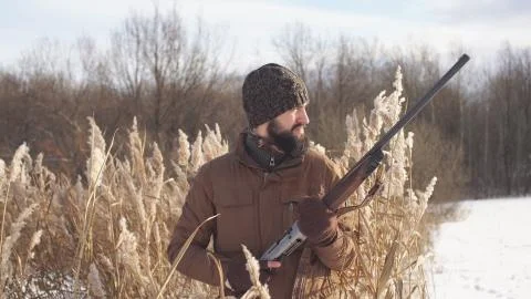 Hunter with a beard is going to hunt his prey, game, close- up of the hunter Stock Photos