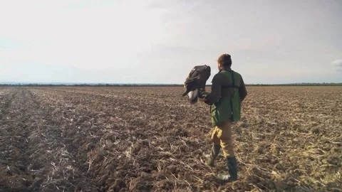 Hunter bearing eagle, walking and hunting 動画素材 257048859