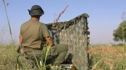 Hunter behind a camouflage net 動画素材 54737517