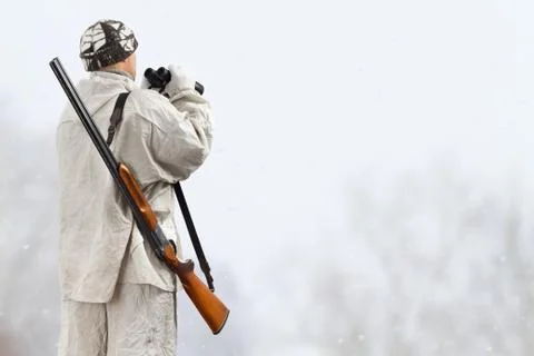 Hunter with binoculars in the winter field Stock Photos