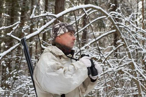Hunter with binoculars in the winter forest Stock Photos