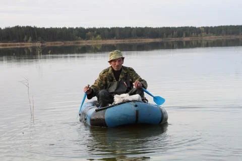 Hunter in a boat 스톡 사진