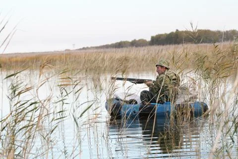 Hunter in a boat Foto stock
