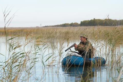 Hunter in a boat Foto stock