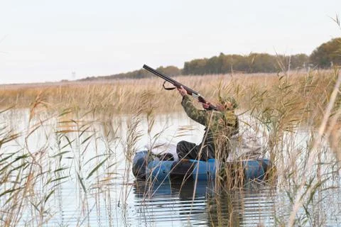 Hunter in a boat 스톡 사진