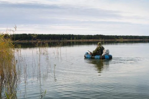 Hunter in a boat Foto stock