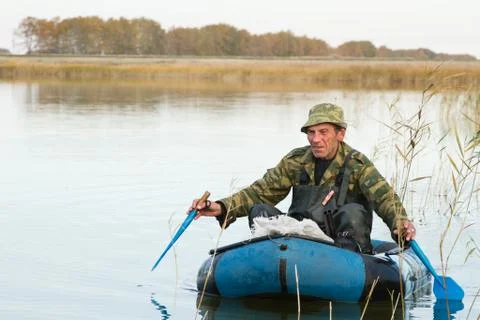 Hunter in a boat Foto stock