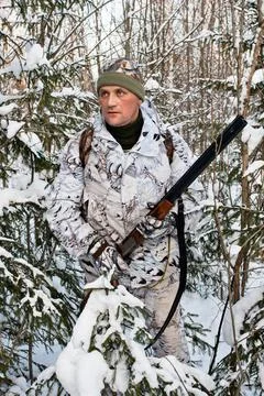 The hunter in the bushes in winter Stock Photos