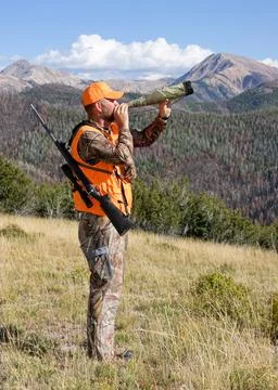 Hunter calling for elk in the mountains Stock Photos