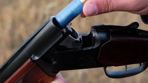 The hunter charges the rifle Stock Footage 124959238