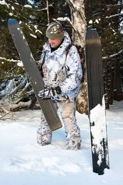 Hunter cleans skis Stock Photos