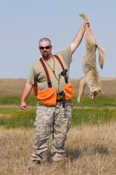 Hunter with a Coyote Stock Photos