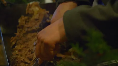 Hunter Cutting pieces of meat in 4K Slow motion 60fps Stock Footage 126625424