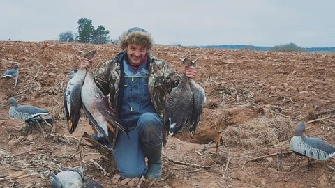 Hunter with dead geese. Extraction. Goose Hunter. hunting trophy Stock Footage 116197115