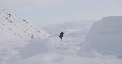 Hunter digs for ice Stock Footage 138238589