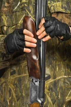 Hunter disassembles the shotgun Stock Photos