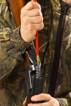 Hunter do shotgun maintenance Stock Photos