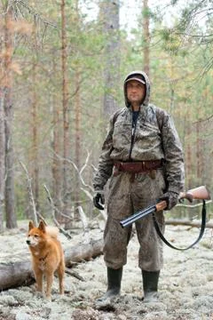 Hunter with dog in the pine forest Stock Photos