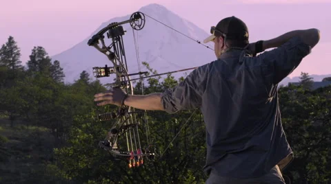 Hunter Draws Backs His Compound Bow And Releases His Arrow (Slow Motion) Stock Footage 68109072