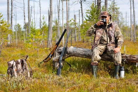 The hunter drinking tea on the halt Stock Photos