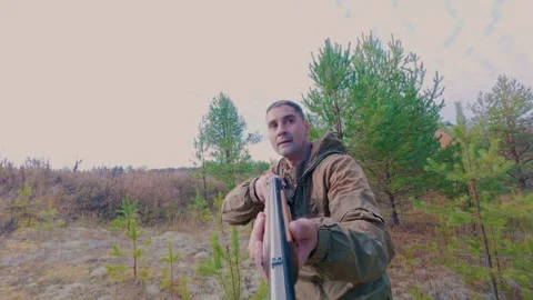 The hunter eagerly tracks down the target in the forest and shoots at it. Stock Footage 318871562