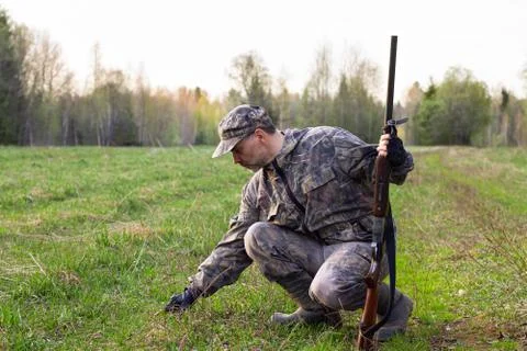 The hunter examines the tracks on the grass Stock Photos