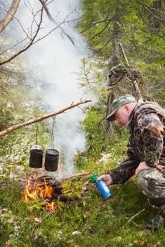 Hunter in forest fire ignites Stock Photos