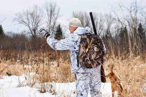 Hunter gives the dog command Stock Photos