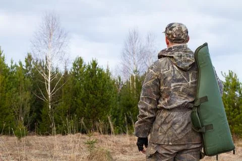 Hunter with a gun in a case Stock Photos