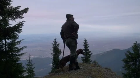 Hunter with his dog on a rock Stock Footage