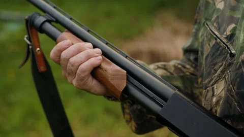 The hunter holds a weapon in his hand and reload it Stock Footage 196628378