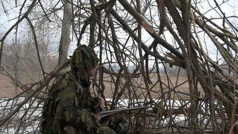 Hunter in a hut of branches Stock Footage 106716100