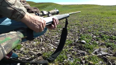 Hunter loading bullet into sniper rifle Stock Footage 83184081