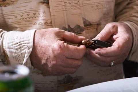 Hunter loading a cartridge with bullets Stock Photos
