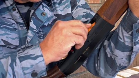 Hunter loads ammo in the gun Stock Footage 82803385