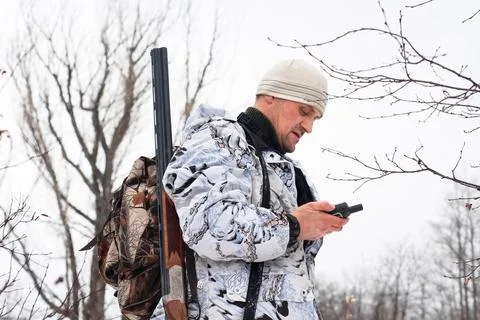 Hunter looking on the mobile  navigation device Stock Photos