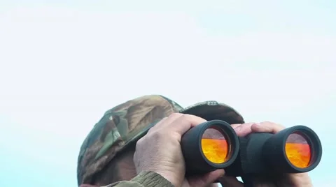 Hunter looks in binoculars Video stock 64311809