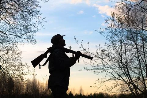 The hunter looks at the evening sky Stock Photos