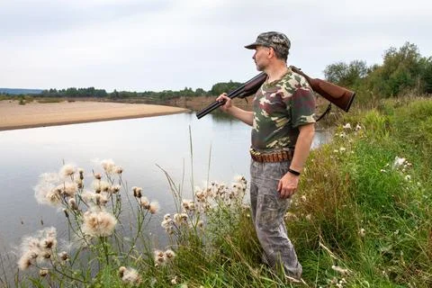 The hunter looks at the river Stock Photos