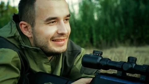 Hunter is lying in a field and smiling Stock Footage 94293156