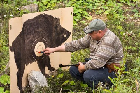 Hunter marking traces from shots on target Stock Photos