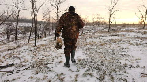 Hunter moving with a gun and a hare in his hands 스톡 동영상 101213735