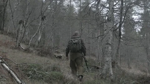 Hunter moving uphill away from camera Stock Footage 43716170