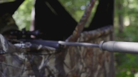 Hunter or Sniper taking  aim from a camouflage blind. Stock Footage 88165271