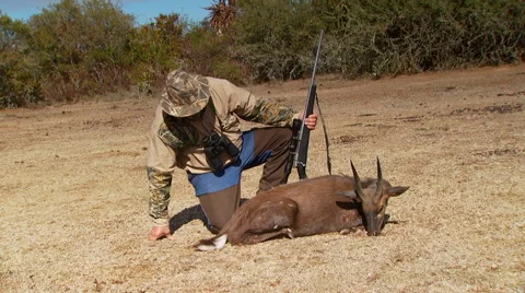 Hunter posing with dead animal Stock Footage 54591324