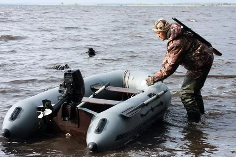 The hunter pulls motor boat Stock Photos