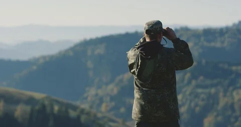 The hunter raised his binoculars, looking for his next destination in the Stock Footage 126636345