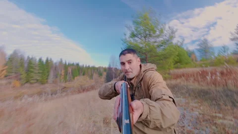 The hunter recklessly runs at the beast through the bushes and shoots it. Stock Footage 318871895